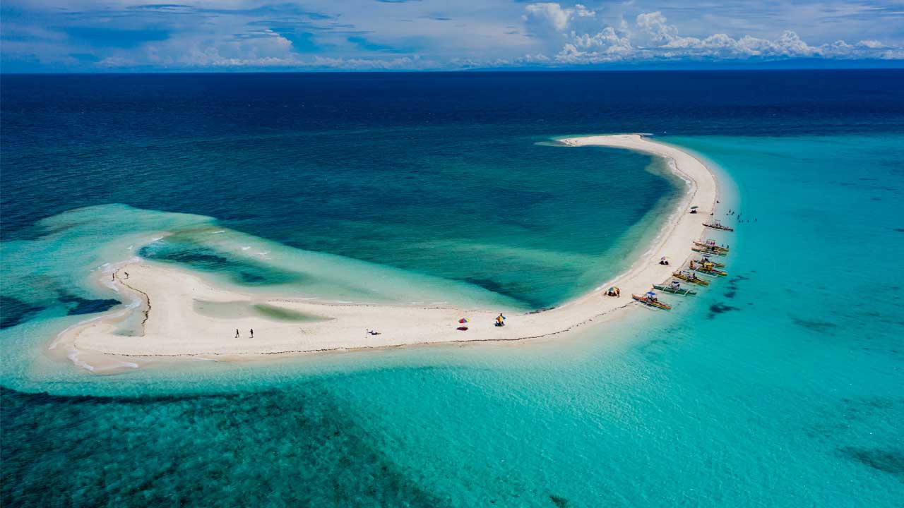 Camiguin vs Siargao comparison - White Island and Cloud 9